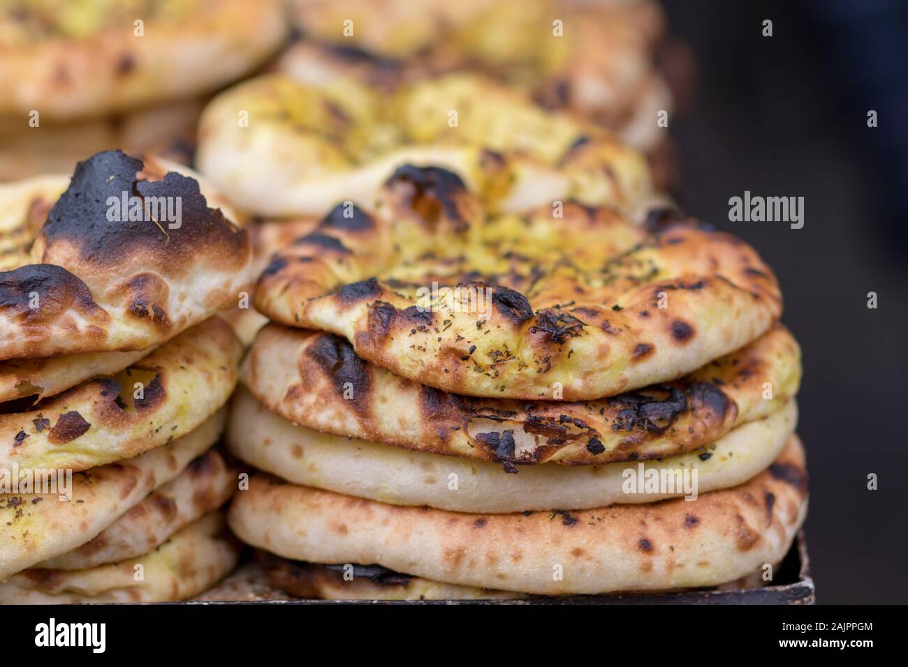 Authentic, flat bread with Za'atar, baked, stacked. The market in ...