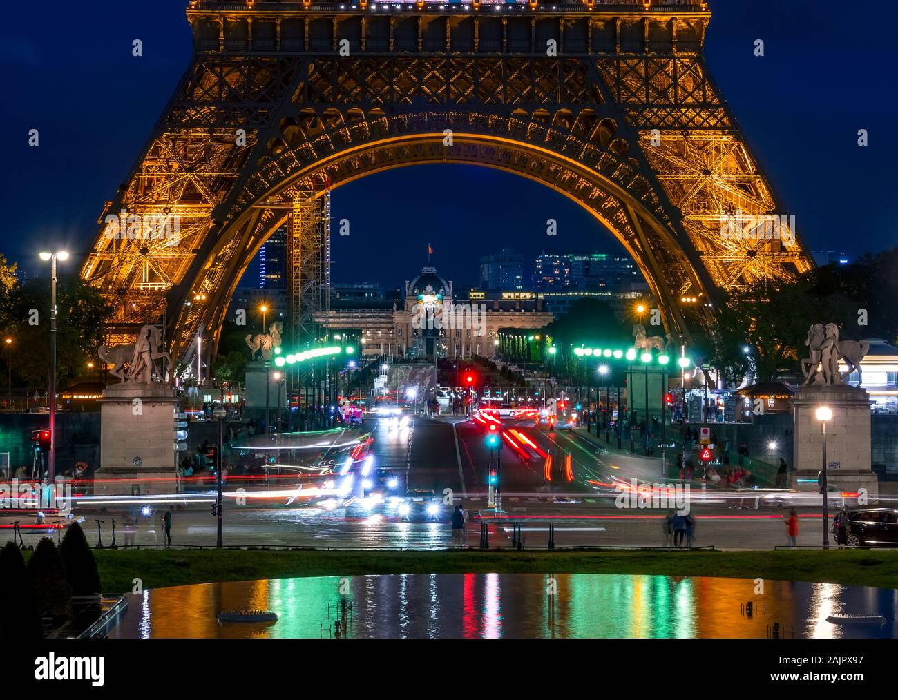 France. Paris. Near the Eiffel tower. Transport, tourists and night illumination of the tower. Reflections in the fountain of the Trocadero Gardens Stock Photo