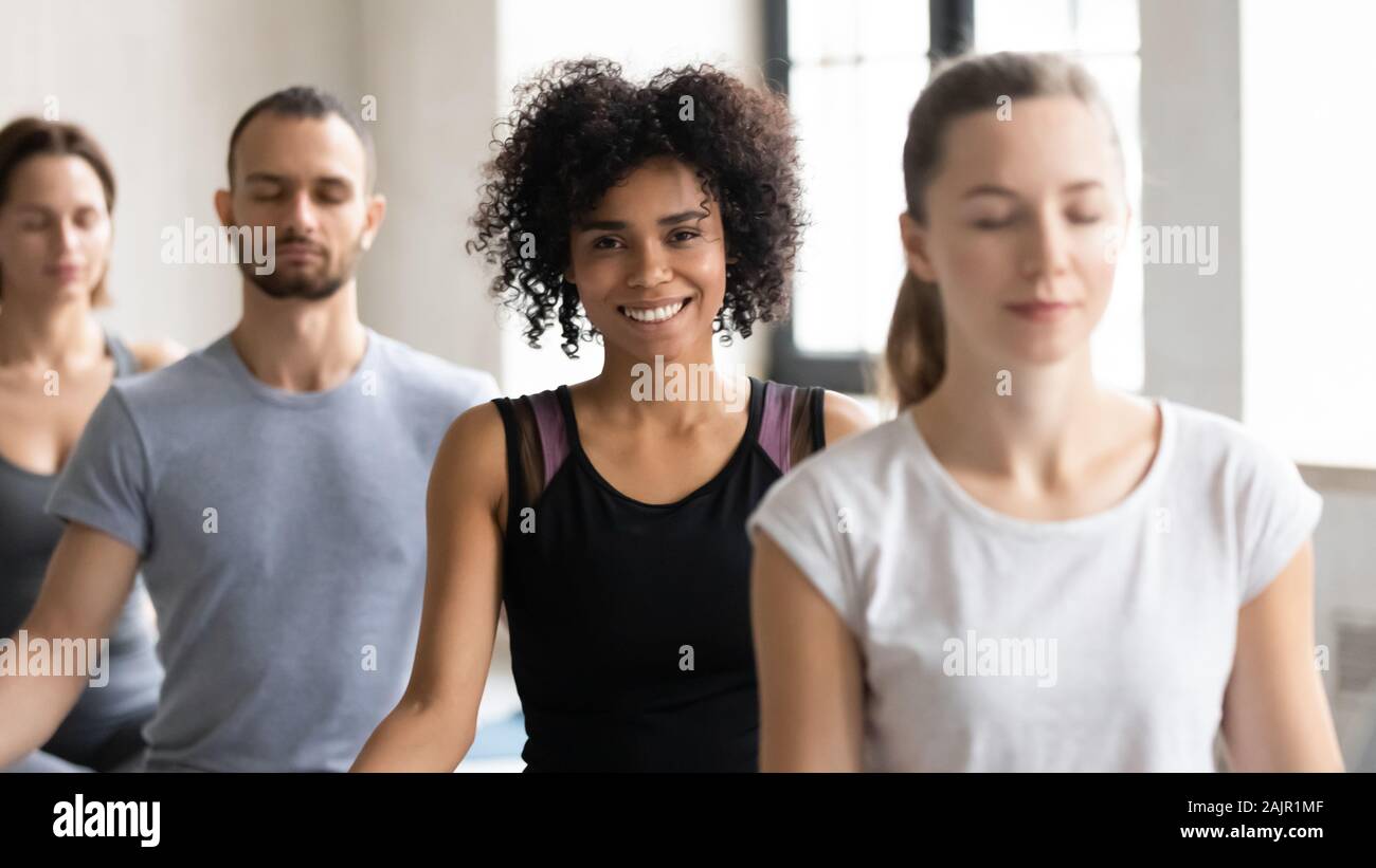 Portrait smiling African American woman at group lesson, practicing yoga Stock Photo