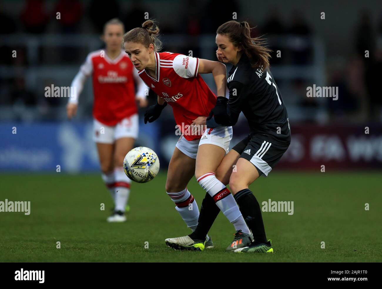 Arsenal's Vivianne Miedema (left) and Birmingham City's Chloe Arthur battle for the ball the FA Women's Super League match at Meadow Park, London. Stock Photo