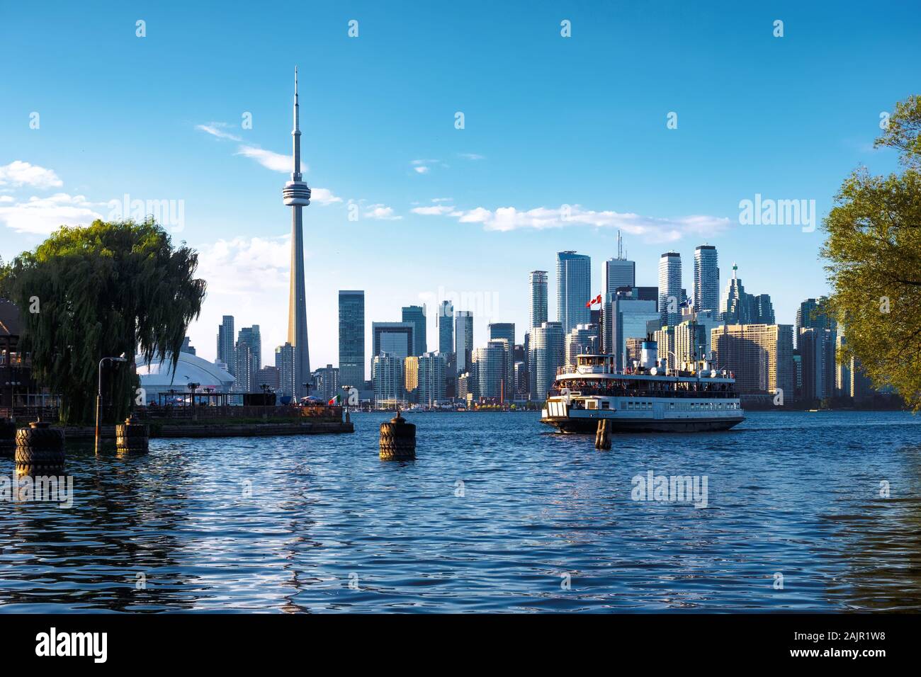 Toronto, Ontario, Canada, view of iconic Toronto skyline showing ferry boat arriving at Centre Island by day in fall season. Stock Photo