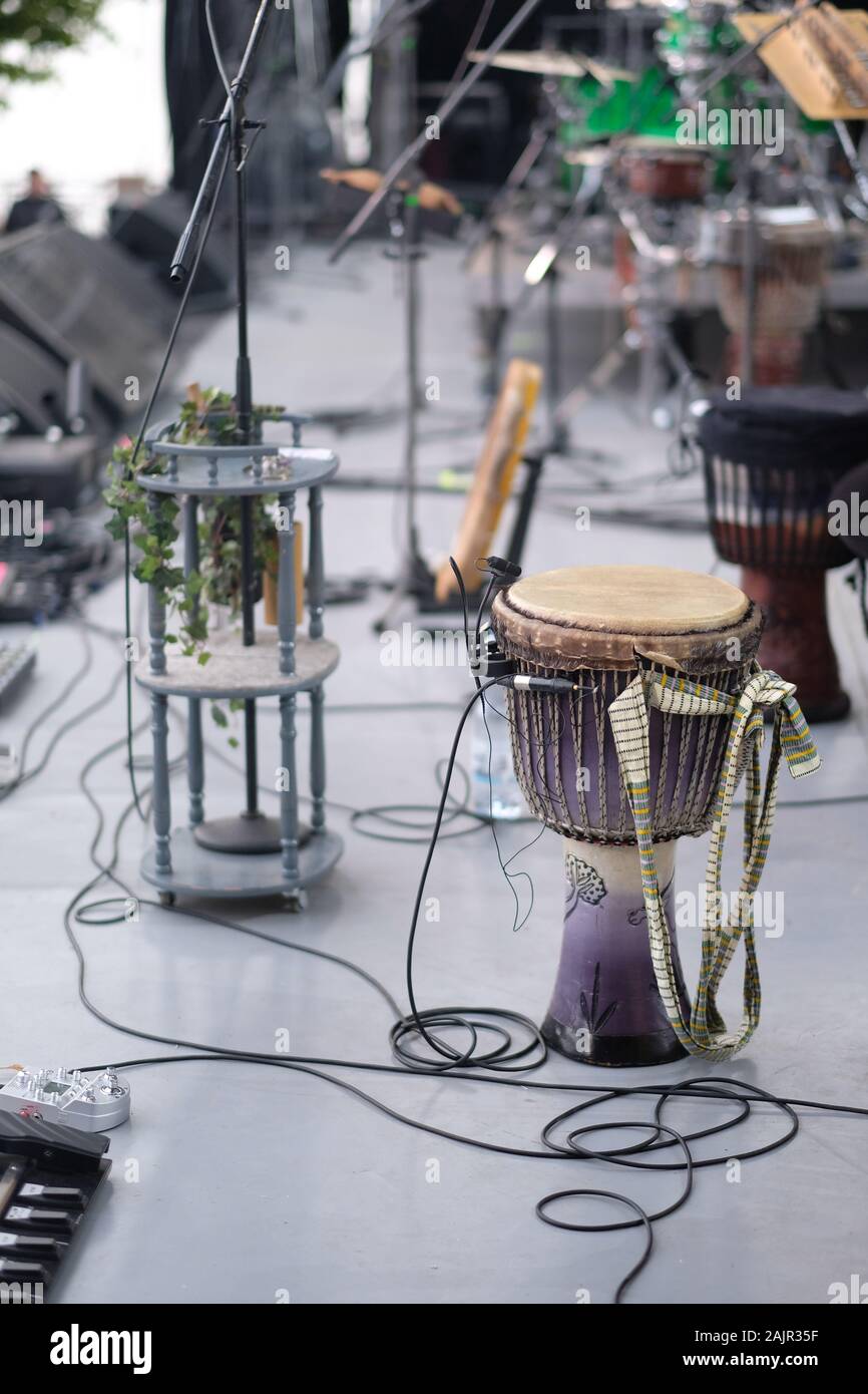 Djembe, a drum from West Africa, on stage with amplifying equipment