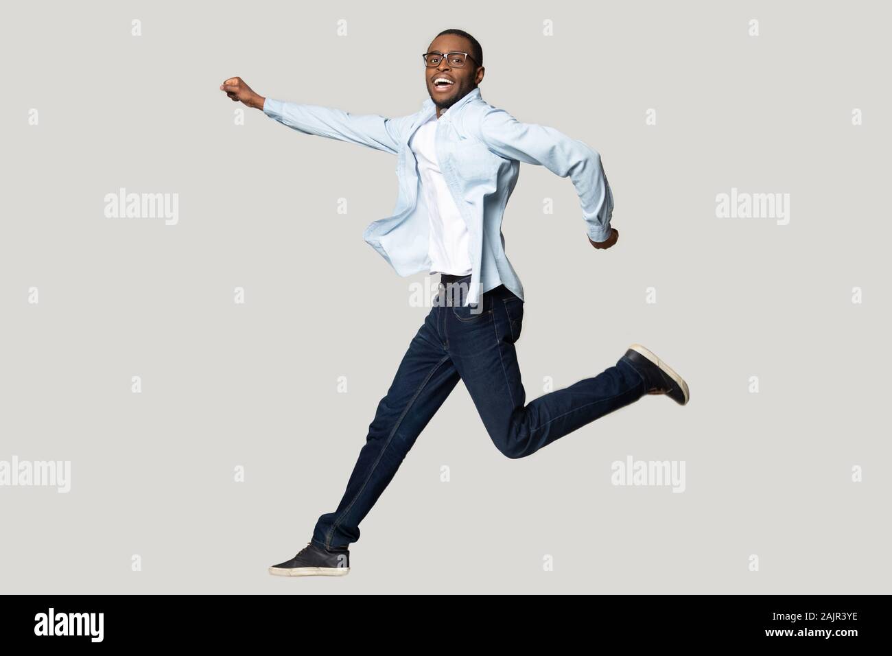 African guy posing in jump isolated on grey studio background Stock Photo