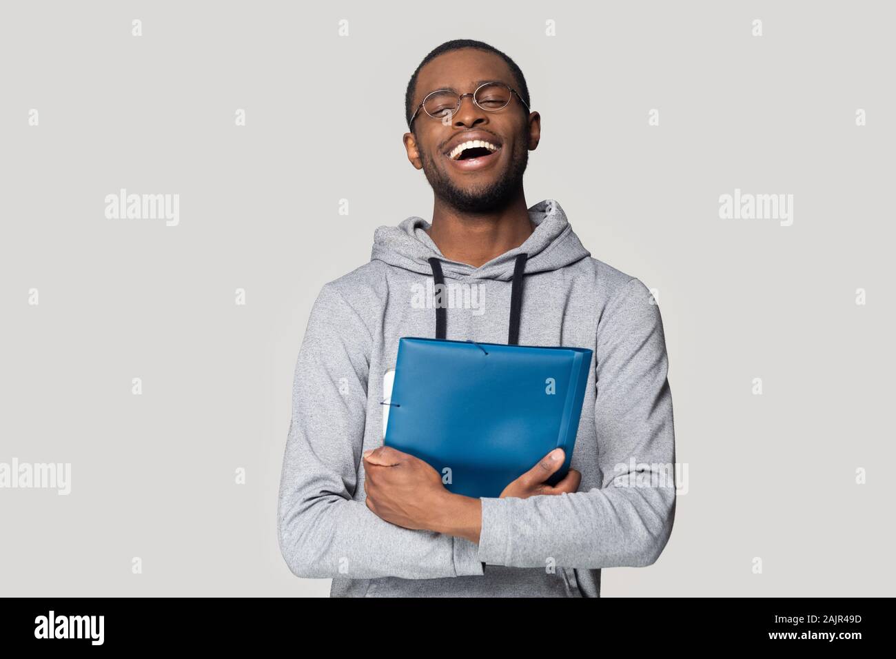 Happy African man keep in hands blue folder studio shot Stock Photo