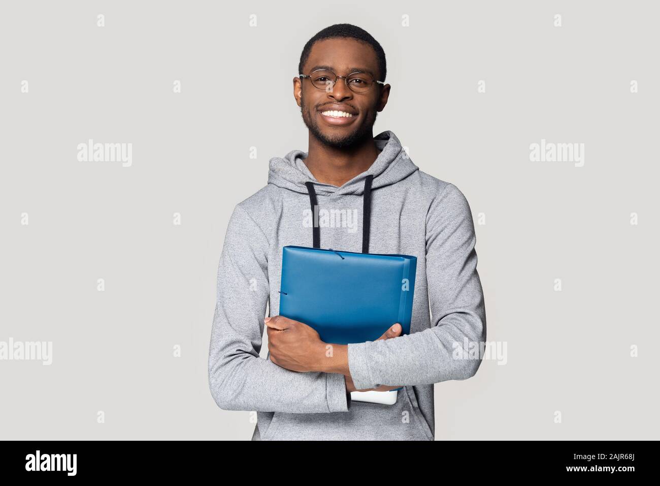 African student holding in hands folder studio shot Stock Photo