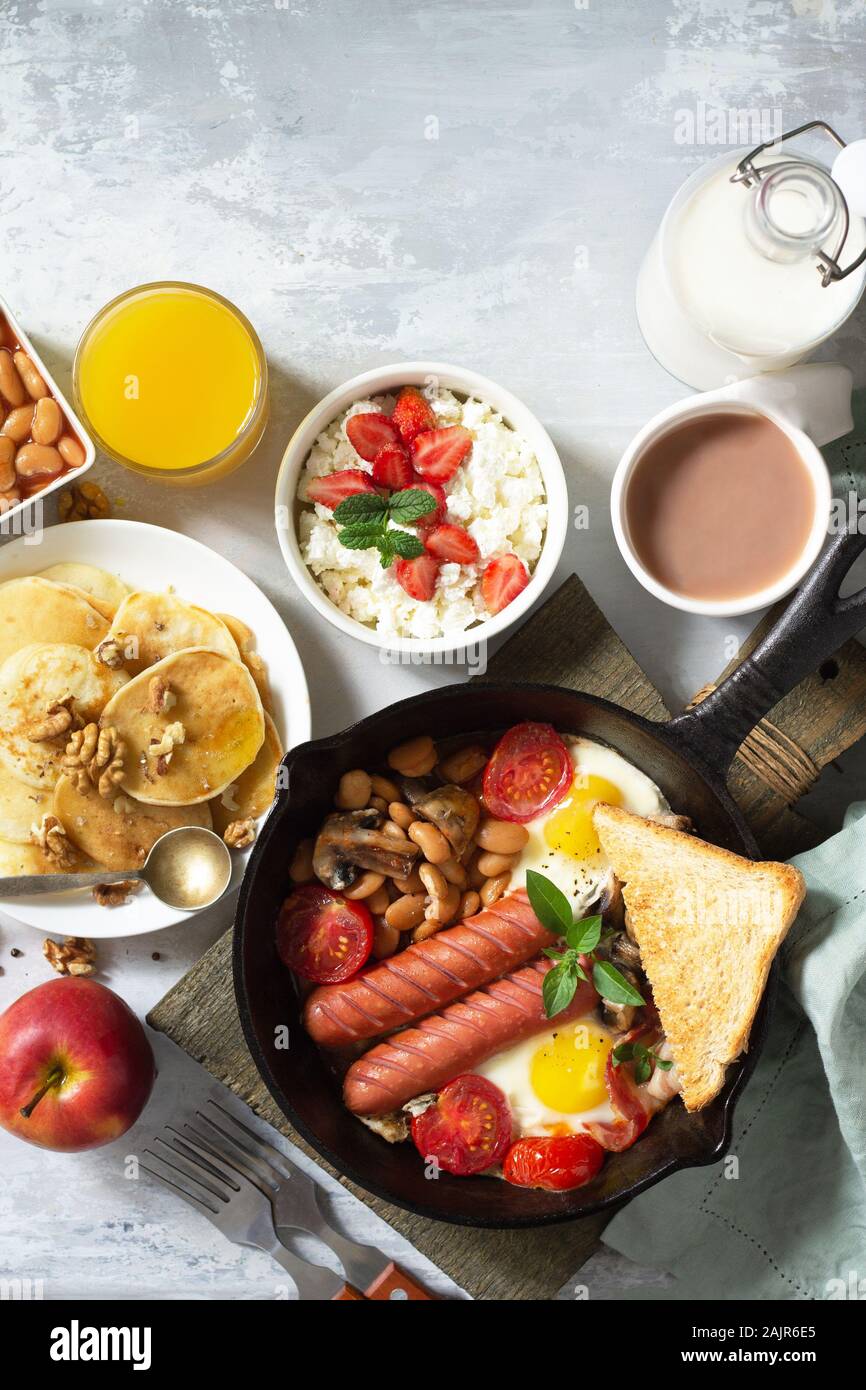 Keto breakfast fried eggs, sausages, beans, bacon, mushrooms, grilled