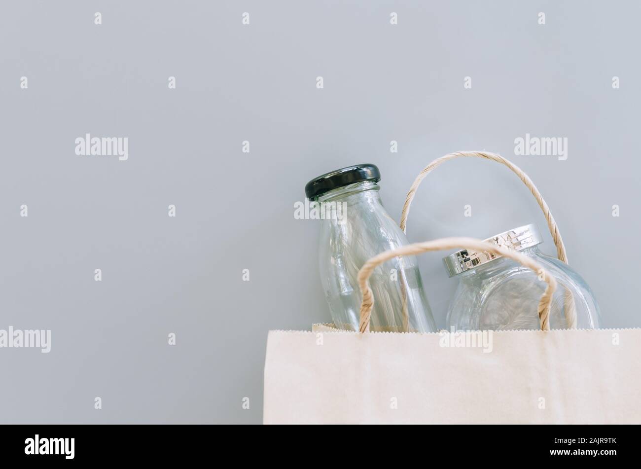 Objects Without Packaging paper bag and glass wares on grey background, no plastic packages, zero ...