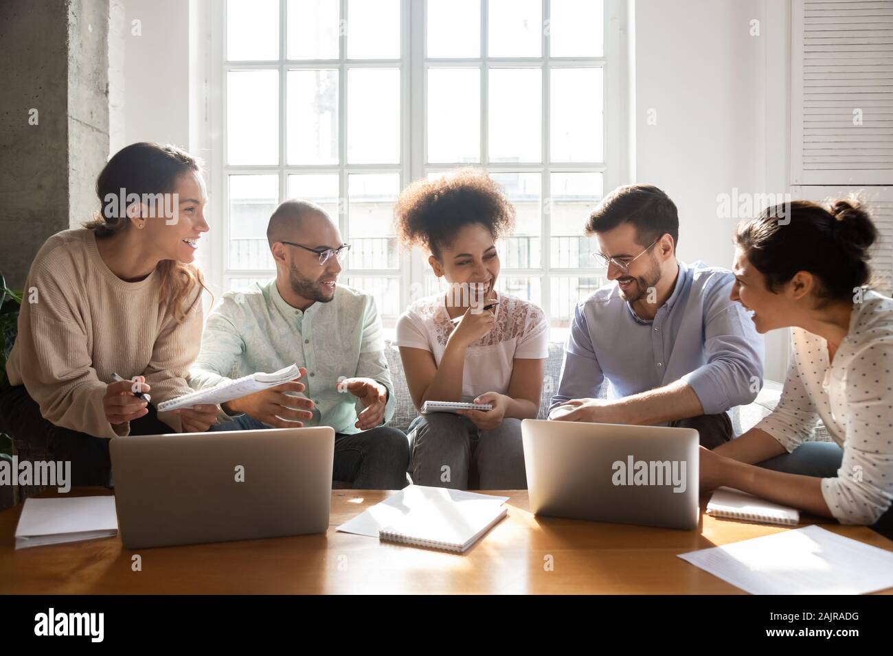 Happy international young people laugh studying indoors Stock Photo