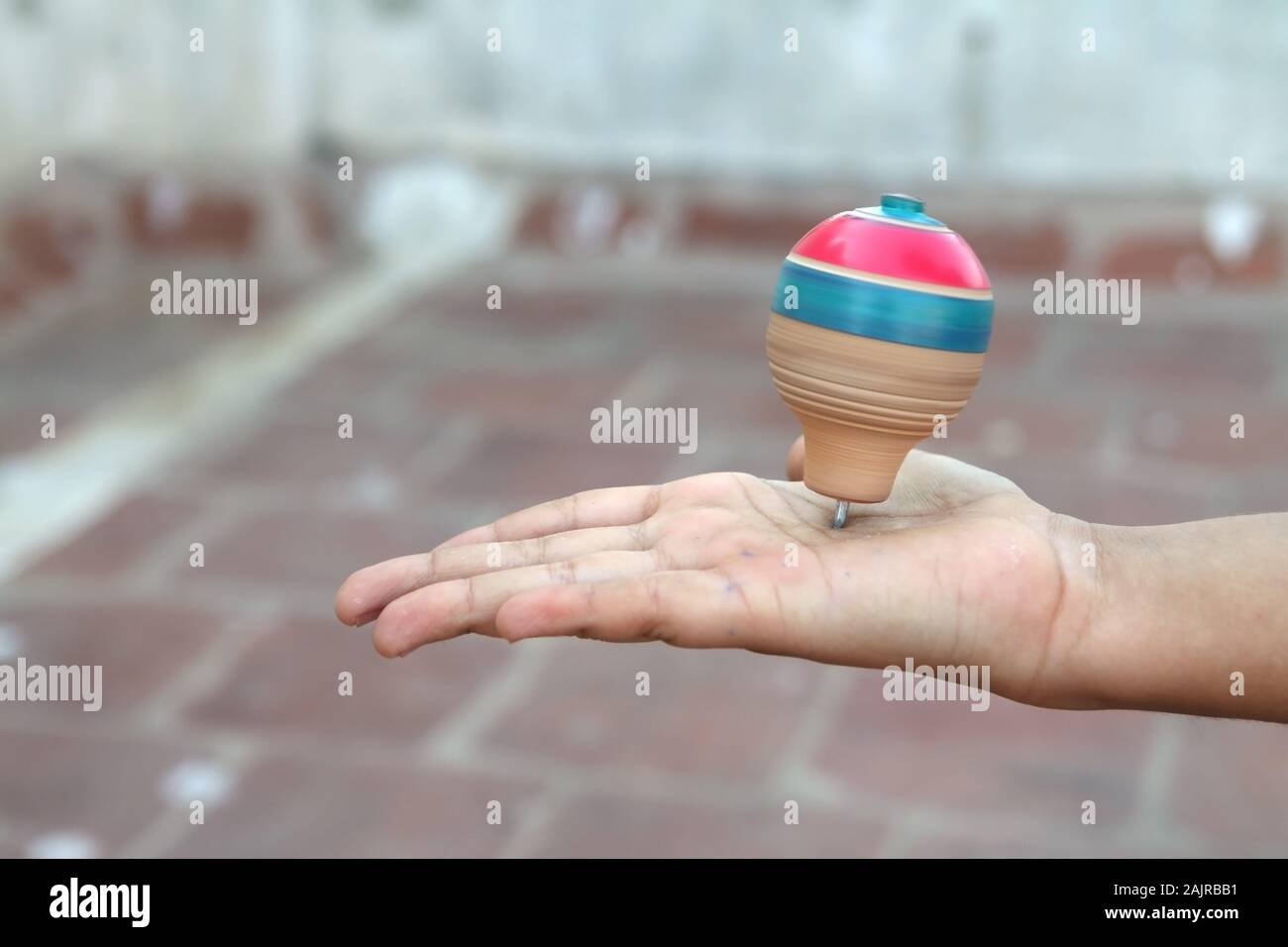Classic wooden spinning top toy with string Stock Photo Alamy