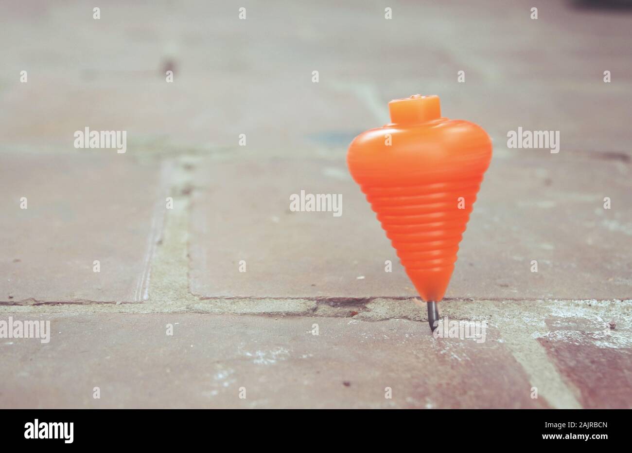 Classic plastic spinning top toy with string Stock Photo