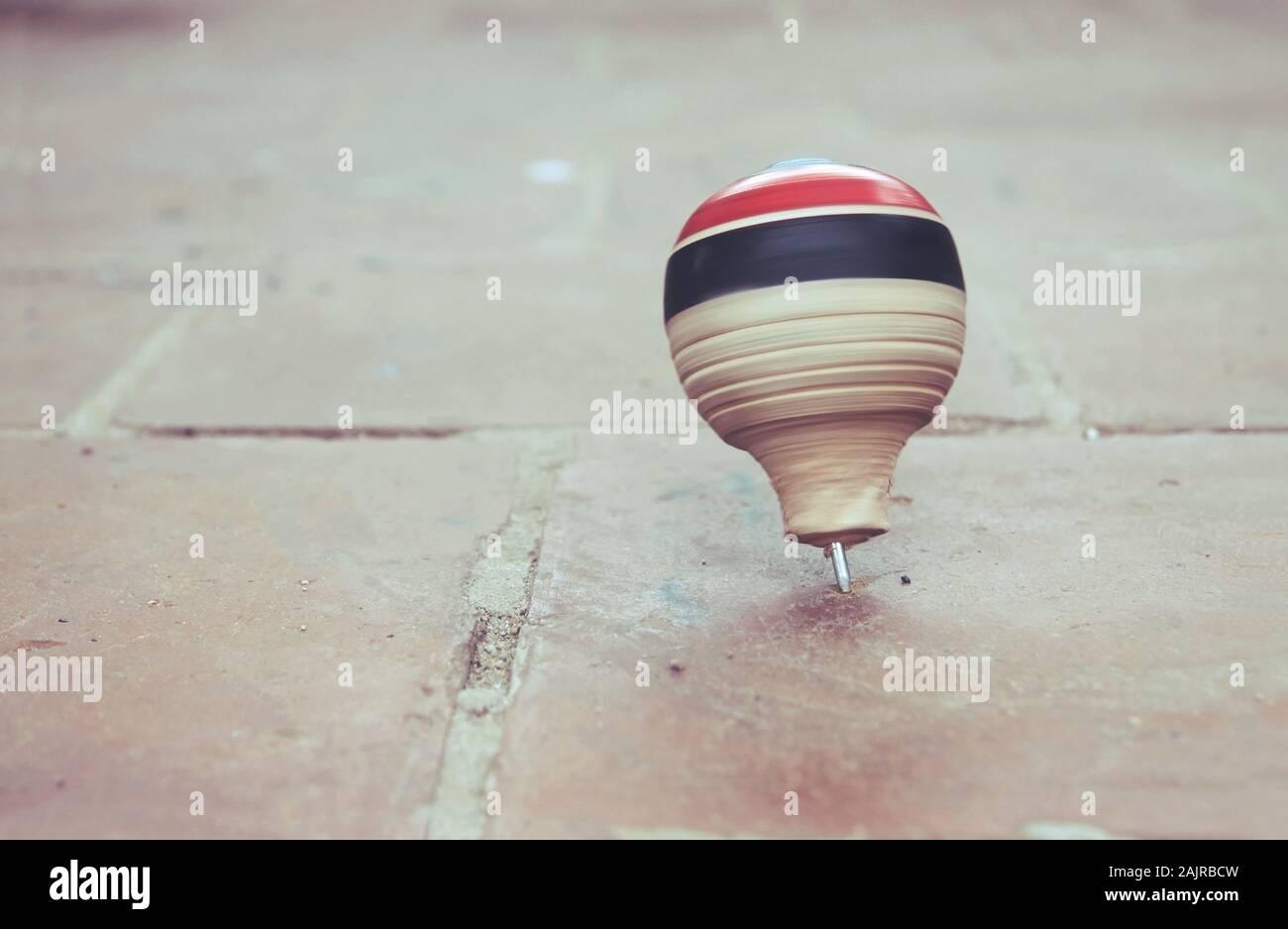 Classic wooden spinning top toy with string Stock Photo Alamy