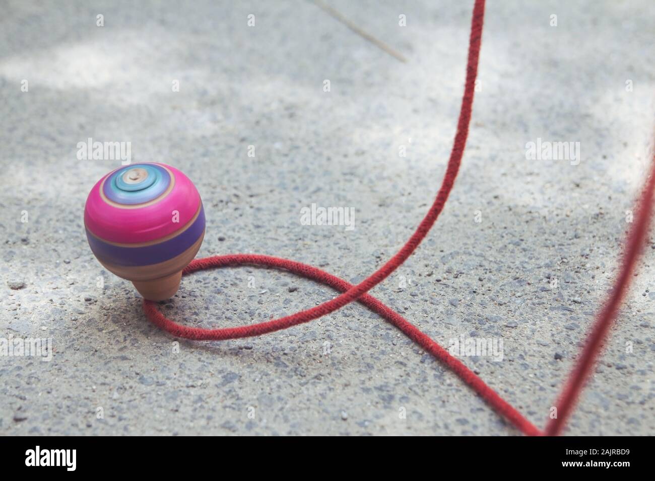 Classic wooden spinning top toy with string Stock Photo Alamy