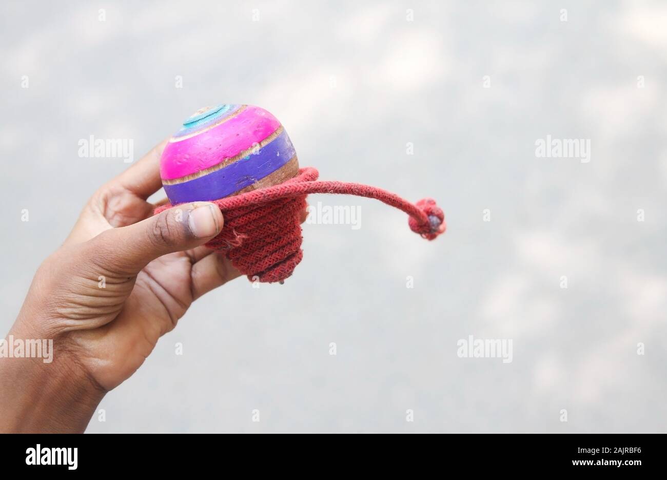 Classic wooden spinning top toy with string Stock Photo Alamy