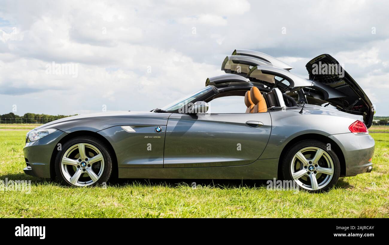 BMW Z4 2.0i convertible sports car multiple image showing the retracting roof. Stock Photo