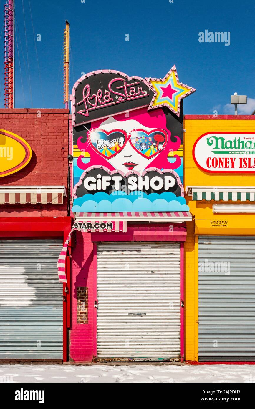 closed and shuttered gift shop sign in winter at at Coney Island