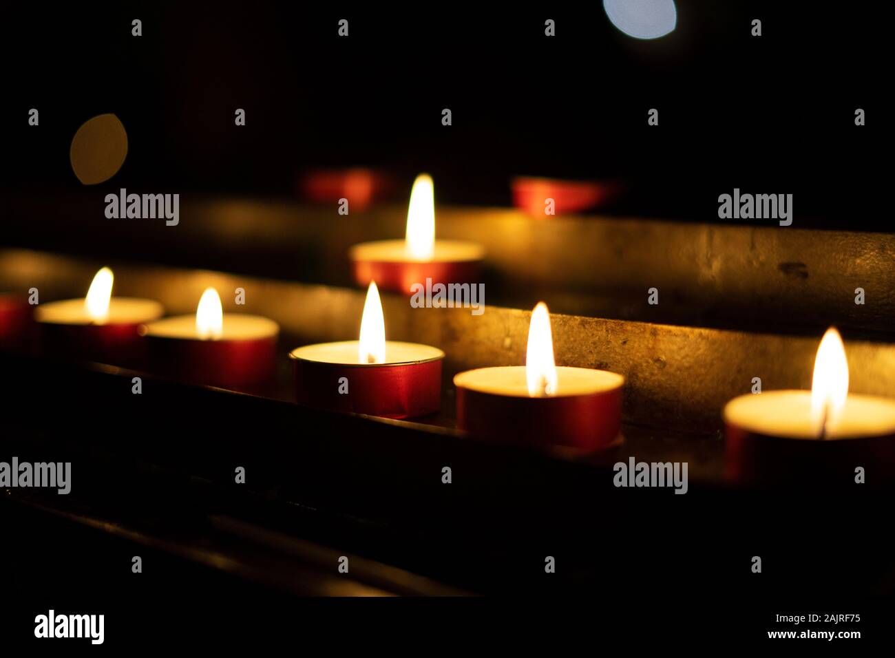 Candles lit red during a session of spiritualism. Concept of occultism, mysticism and black magic. Stock Photo