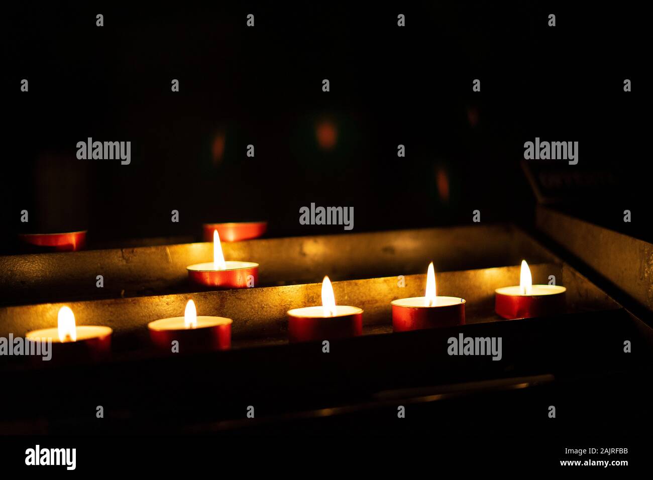 Candles lit red during a session of spiritualism. Concept of occultism, mysticism and black magic. Stock Photo