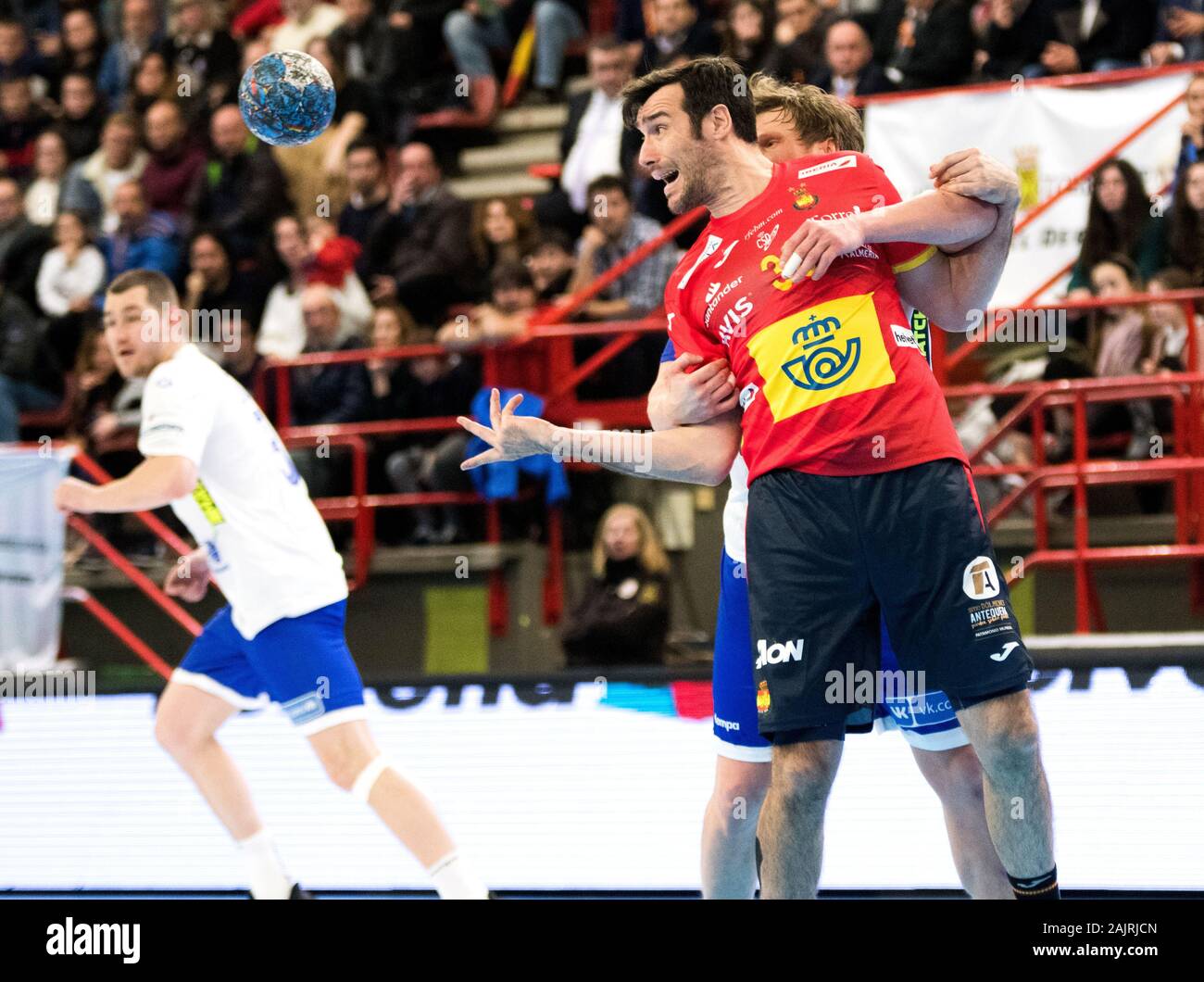 Torrelavega, Spain. 5th January, 2020. Gedeon Guardiola (Spain) passes the ball while is grabbed by Pavel Atman (Russia) during handball match of International Memory 'Domingo Barcenas' between Spain and Russia at Sports Center Vicente Trueba on January 5, 2020 in Torrelavega, Spain. © David Gato/Alamy Live News Stock Photo