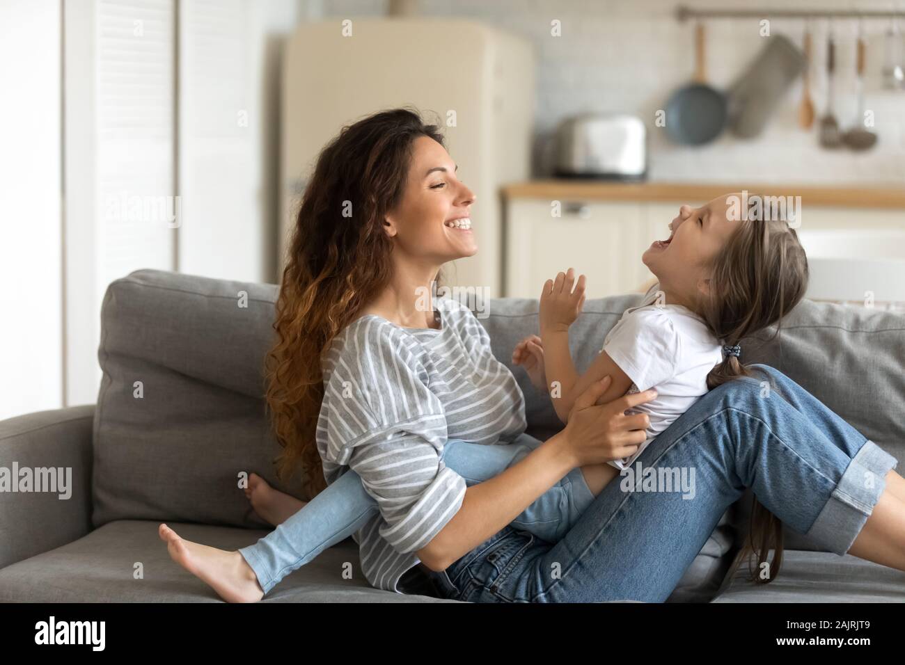 Mother playing with little daughter enjoy time together on weekend Stock Photo