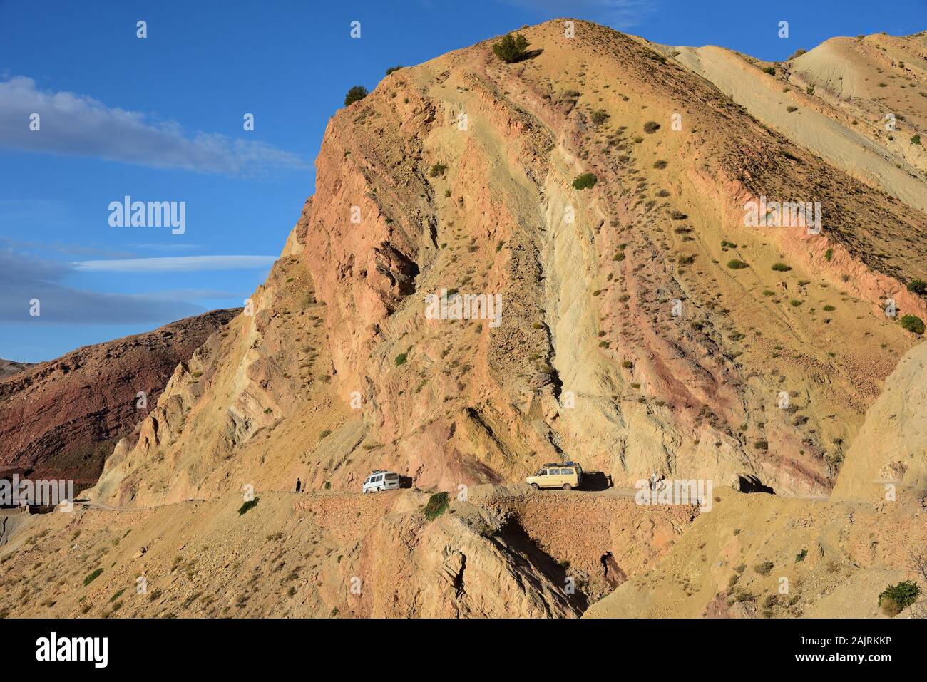 Vehicles navigate their way through a narrow hillside road leading to the village of Tighza, Morocco, Northern Africa. Stock Photo