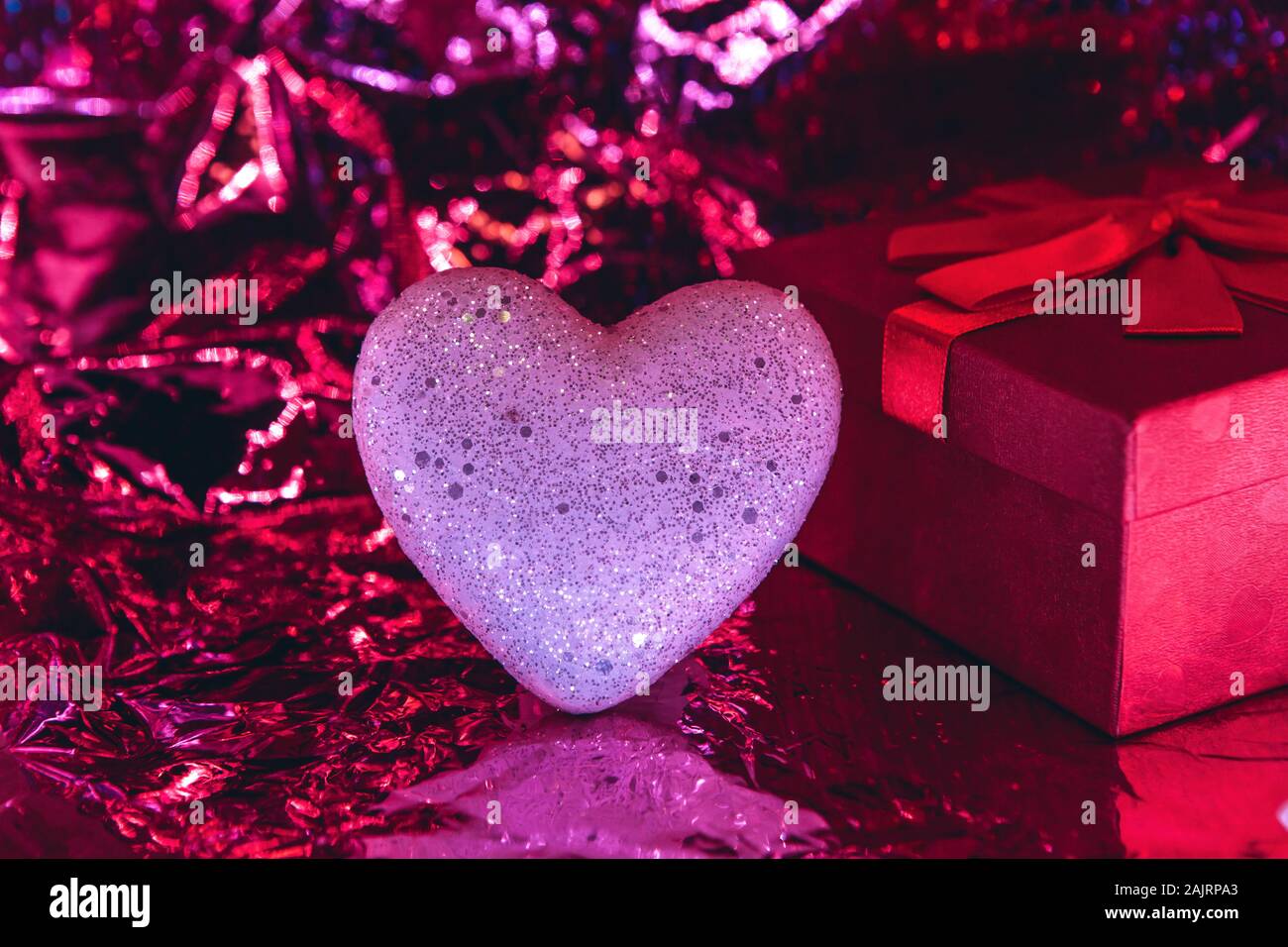 Heart and box with a gift on a trendy glowing red background. Valentine ...