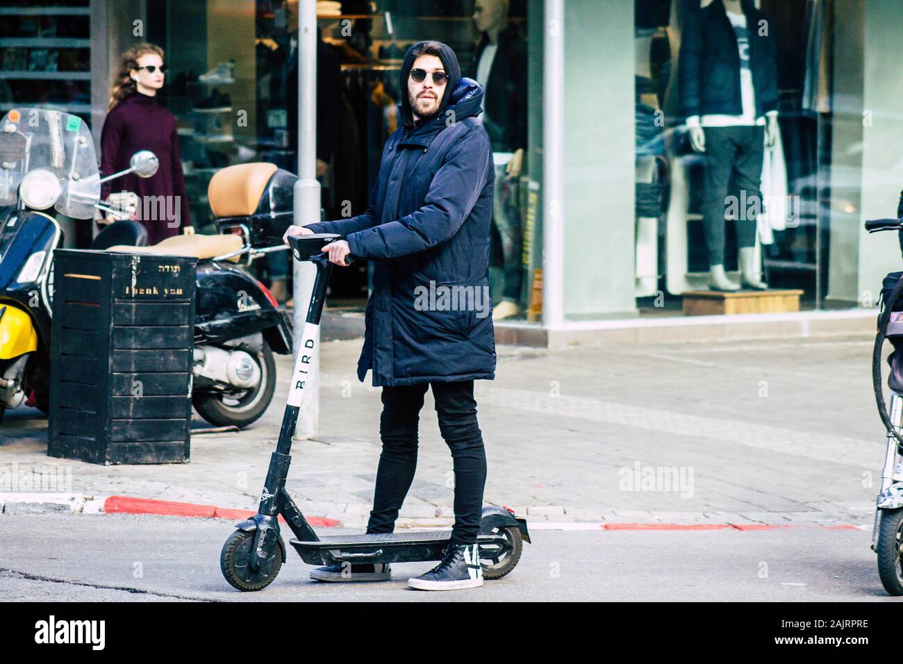 Tel Aviv Israel January 03, 2020 View of unidentified people rolling with  an electric scooter in the streets of Tel Aviv in winter Stock Photo - Alamy