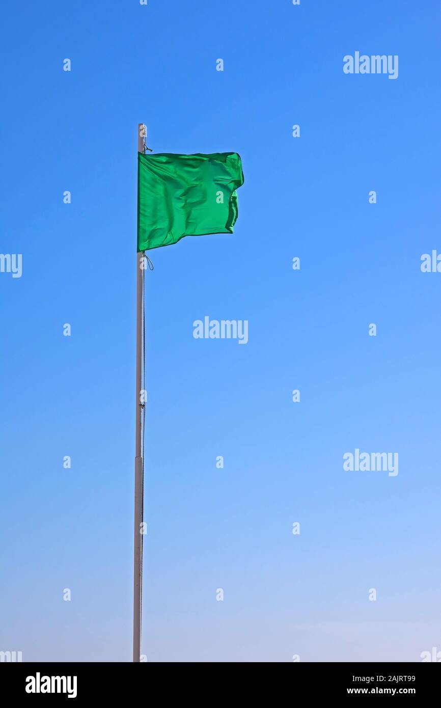Green flag, green for go, beach flag, safe for bathing - low hazard, calm conditions Stock Photo