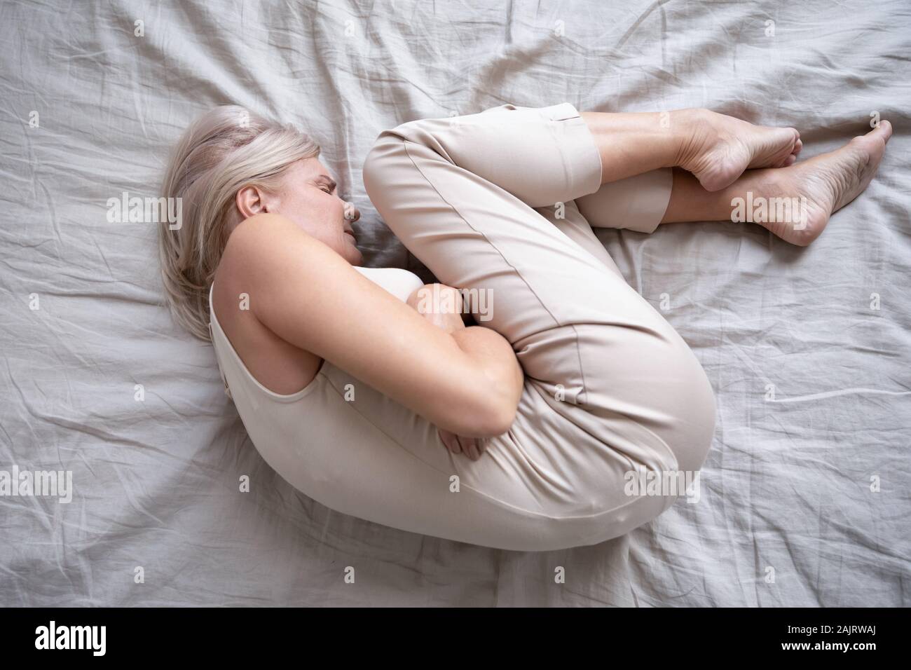 Top view of old woman suffer from painful stomach ache Stock Photo
