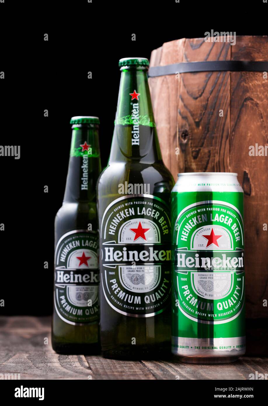 LONDON, UK APRIL 27, 2018 Bottles and aluminium can of Heineken Lager Beer next to wooden