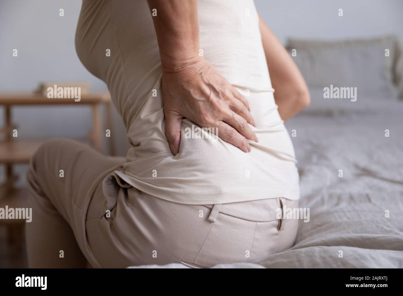 Close up of unhealthy elderly woman having backache Stock Photo