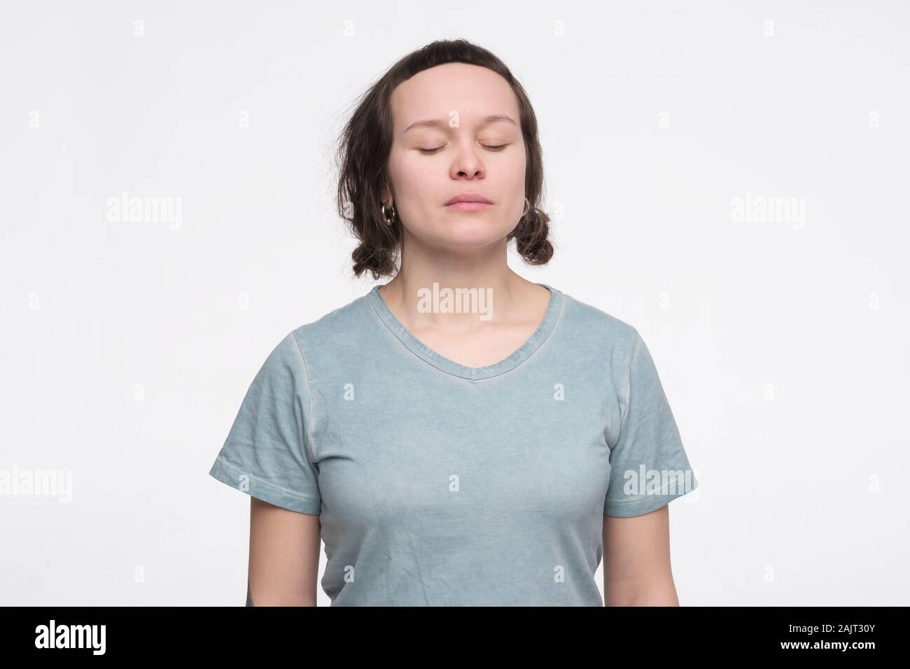 Young caucasian woman standing with closed eyes, feeling calm and ...