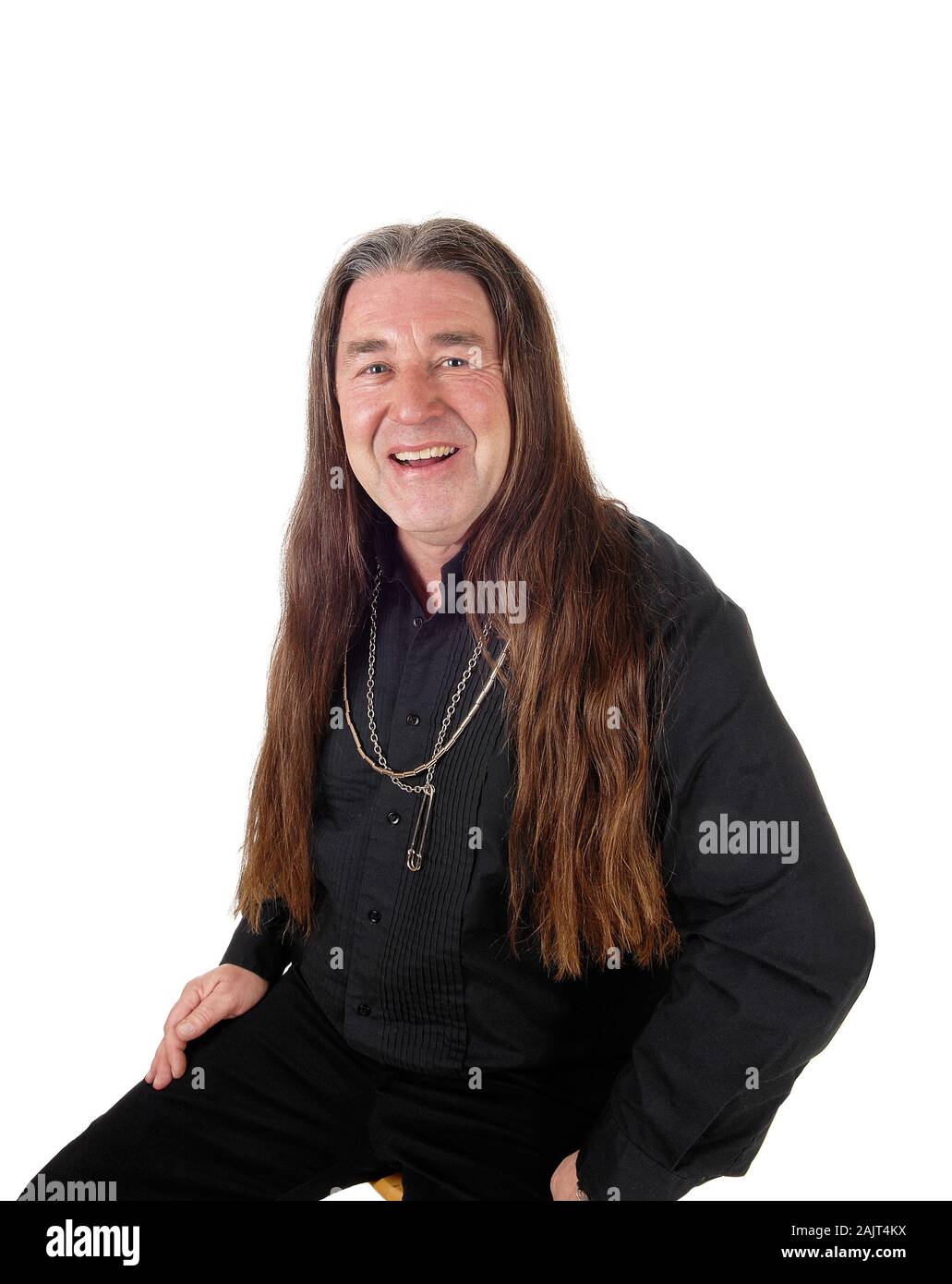 A middle age indigenous man in a portrait picture wearing a black shirt and jewellery with his long hair, isolated for white background Stock Photo