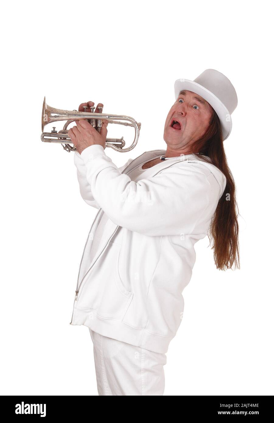 A middle age indigenous man standing in a white outfit and white hat holding his trumpet and screaming, isolated for white background Stock Photo