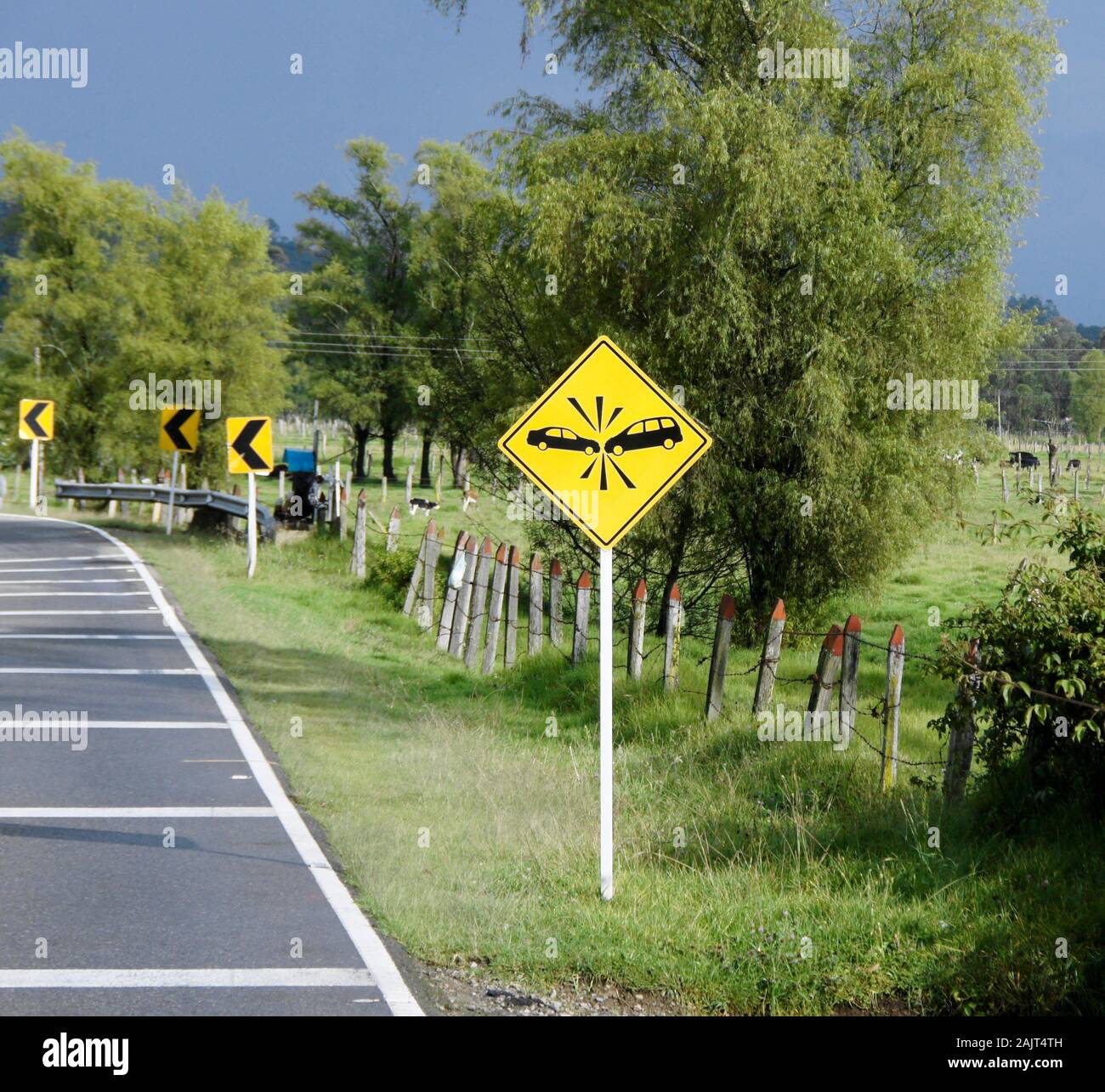 Warning sign on dangerous highway curve in rural Colombia Stock Photo