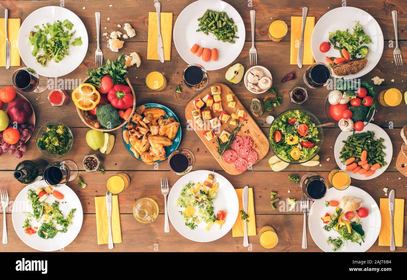 Table settings for family dining on wooden surface Stock Photo - Alamy