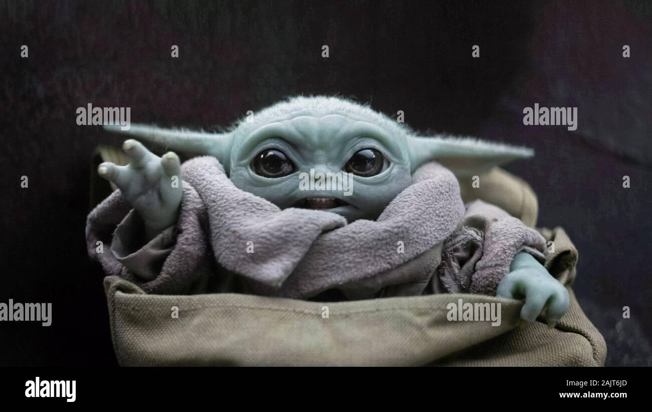 The Child, a mysterious baby of the same species as Yoda with unusual powers and a high bounty on its head from the successful Disney+ series Star Wars: The Mandalorian (2019) created by Jon Favreau. Stock Photo