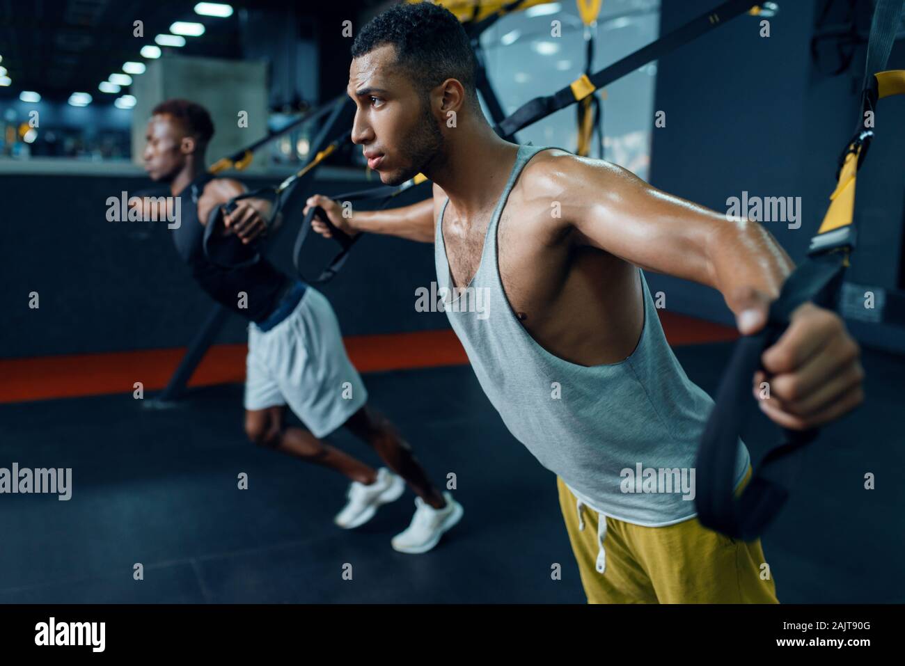 Two athletes at stretching exercise machine Stock Photo - Alamy