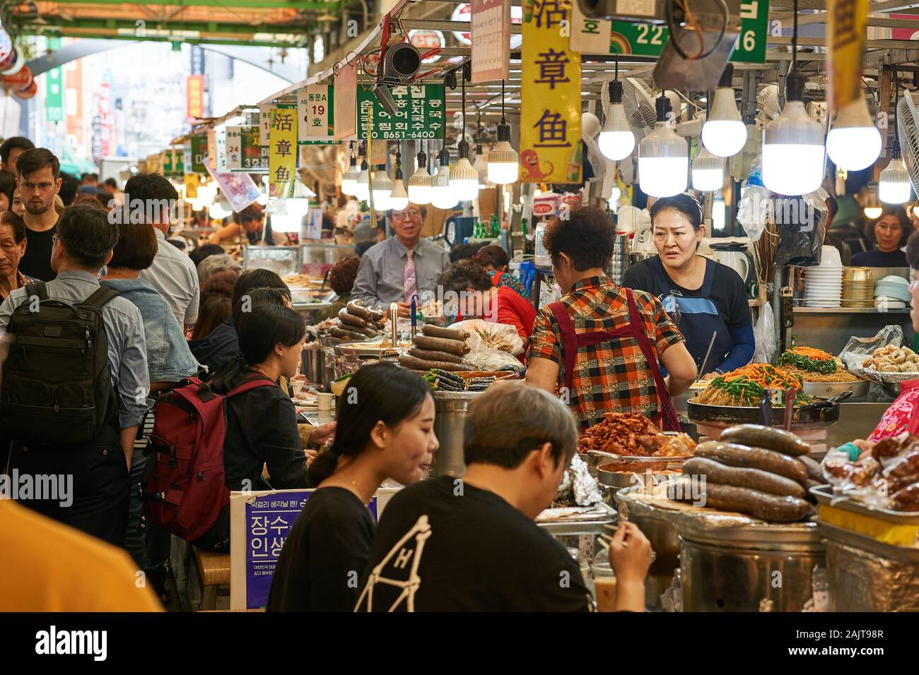 Chefs sell traditional Korean foods to customers at Gwangjang Market in Seoul, South Korea. Stock Photo