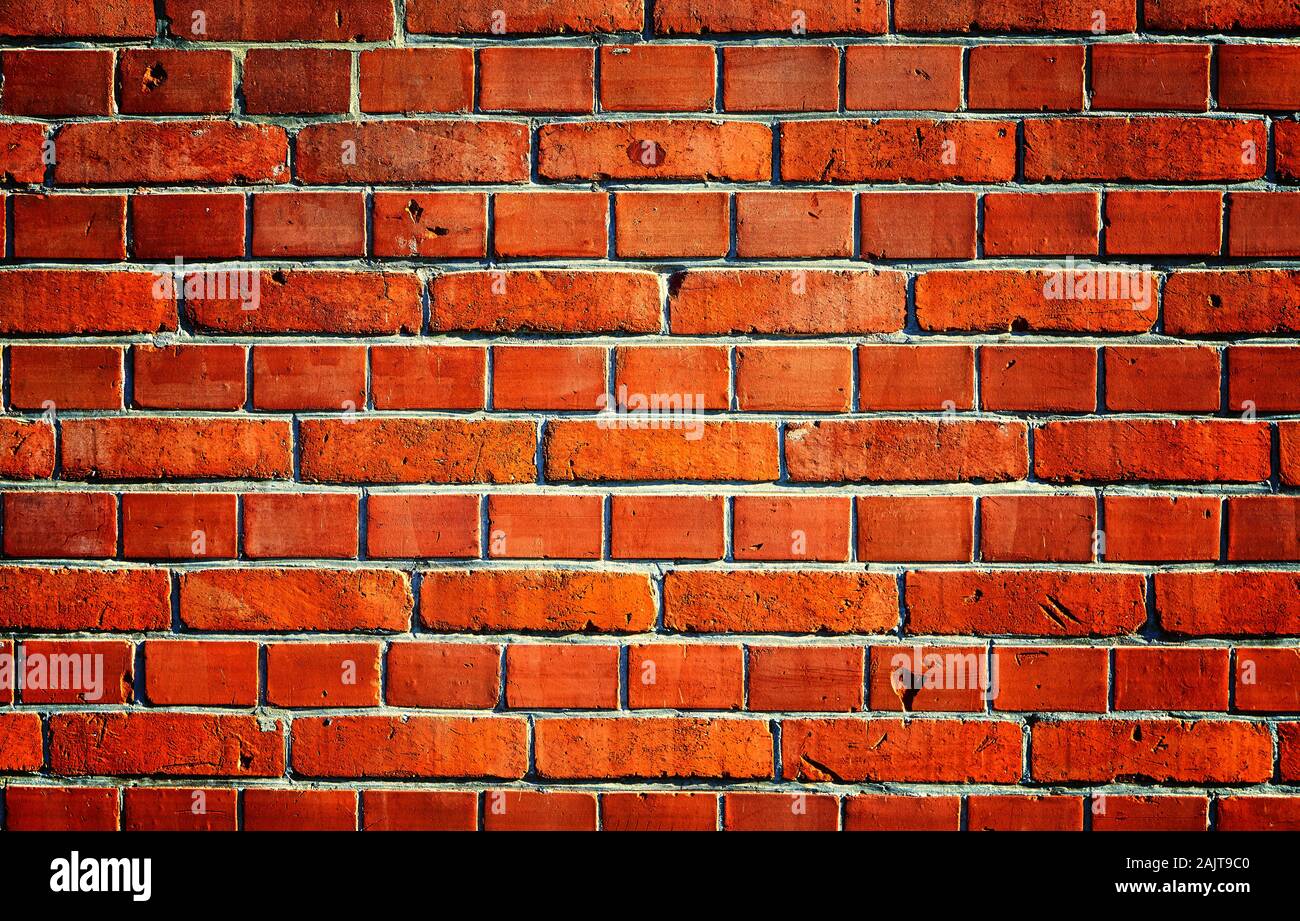 Old Red brick wall. Background with spotlight light in the middle Stock