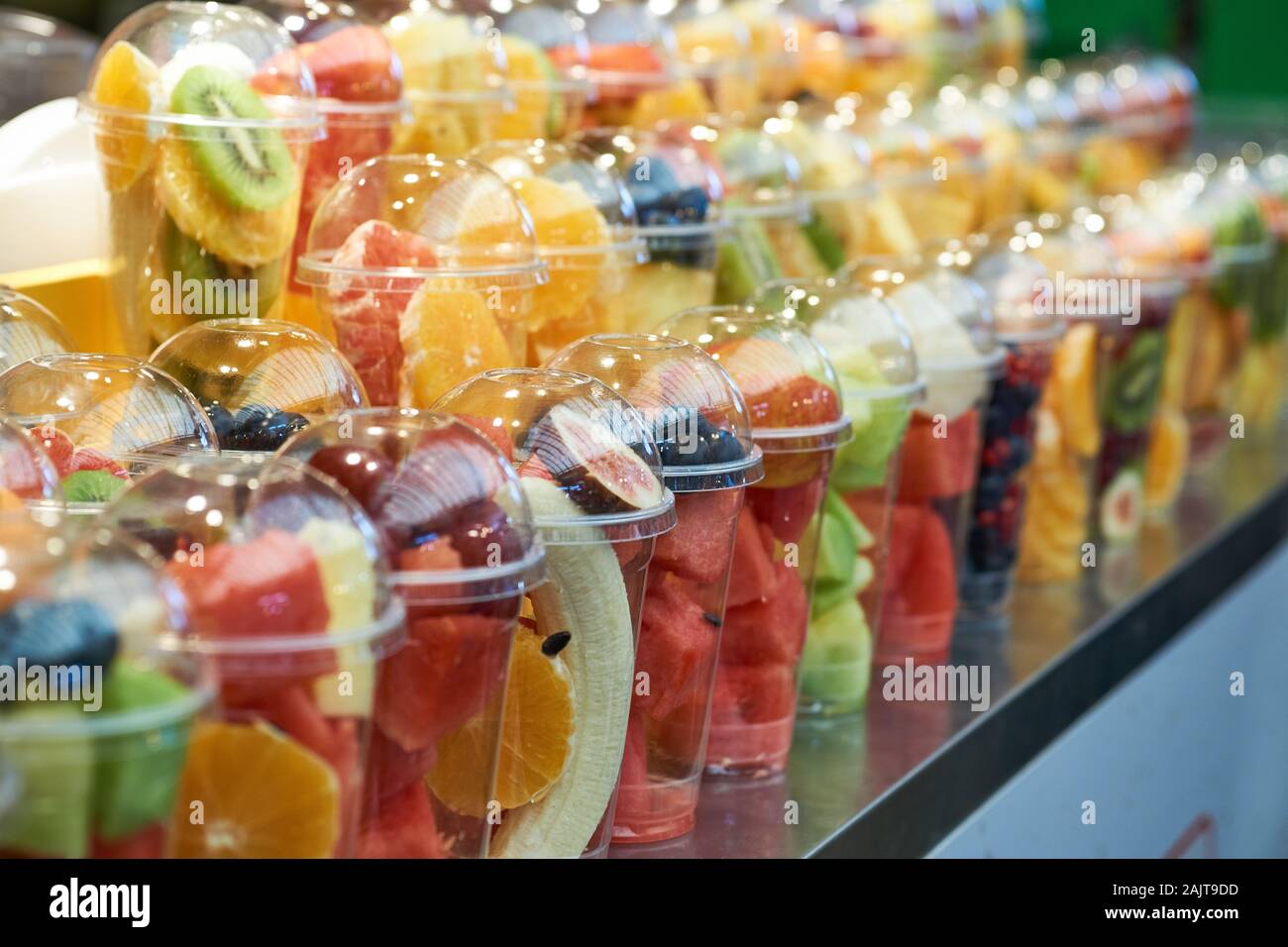 Plastic cups full of fruit at a food stall at Gwangjang Market in Seoul, South Korea. Stock Photo