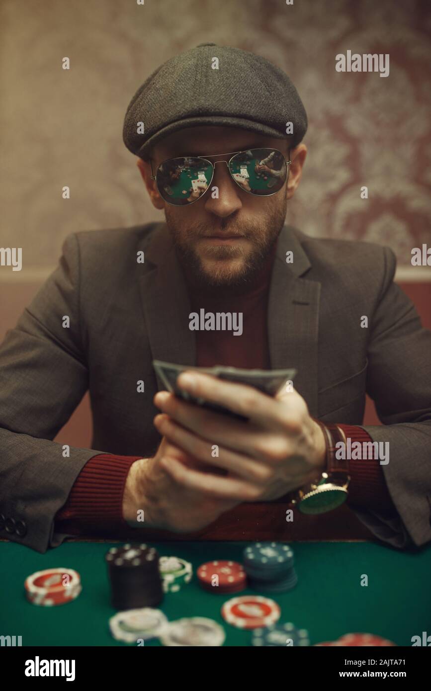 Serious poker player playing in casino Stock Photo