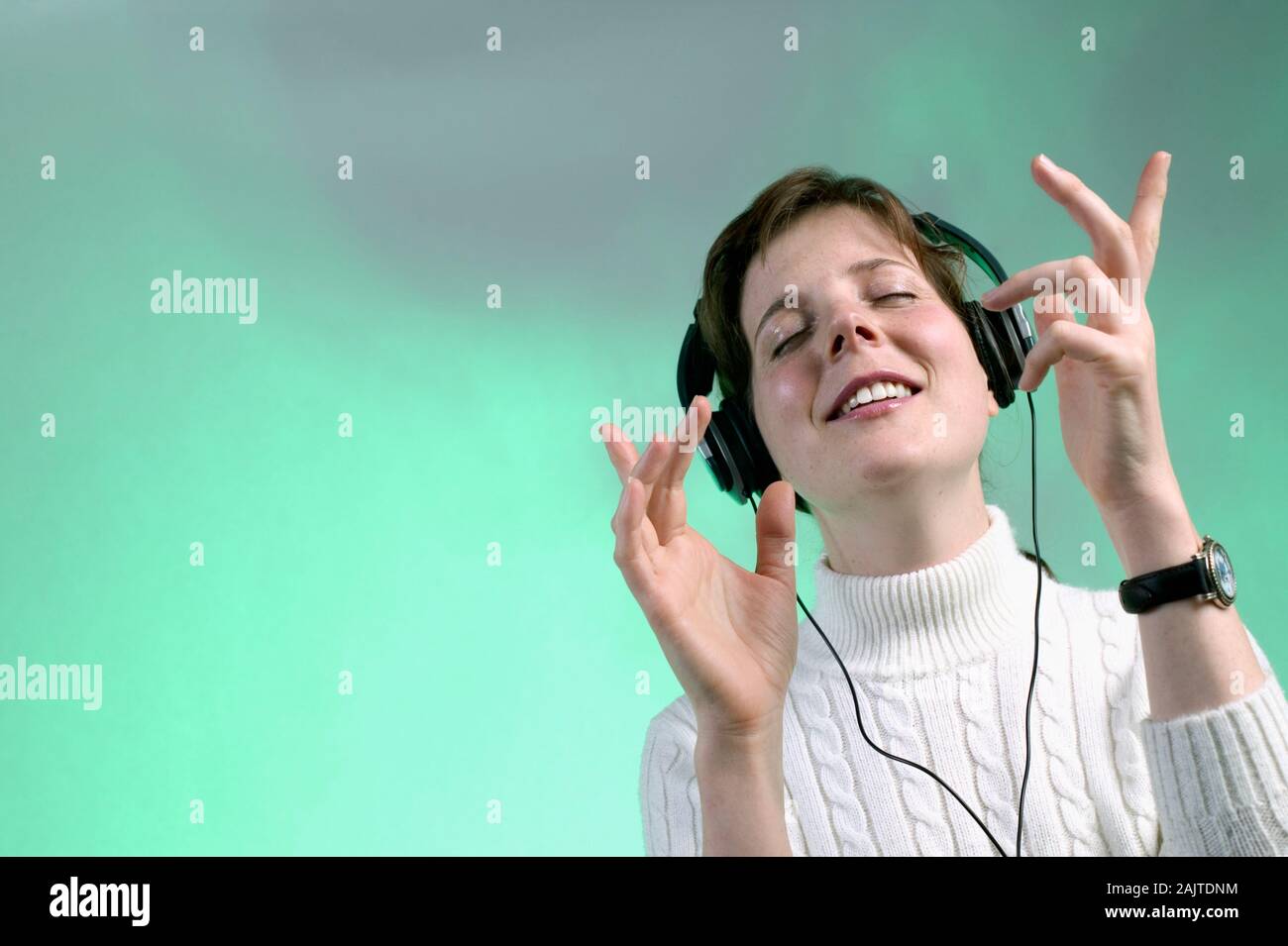 Caucasian Woman Listening To Music On Headphones Stock Photo