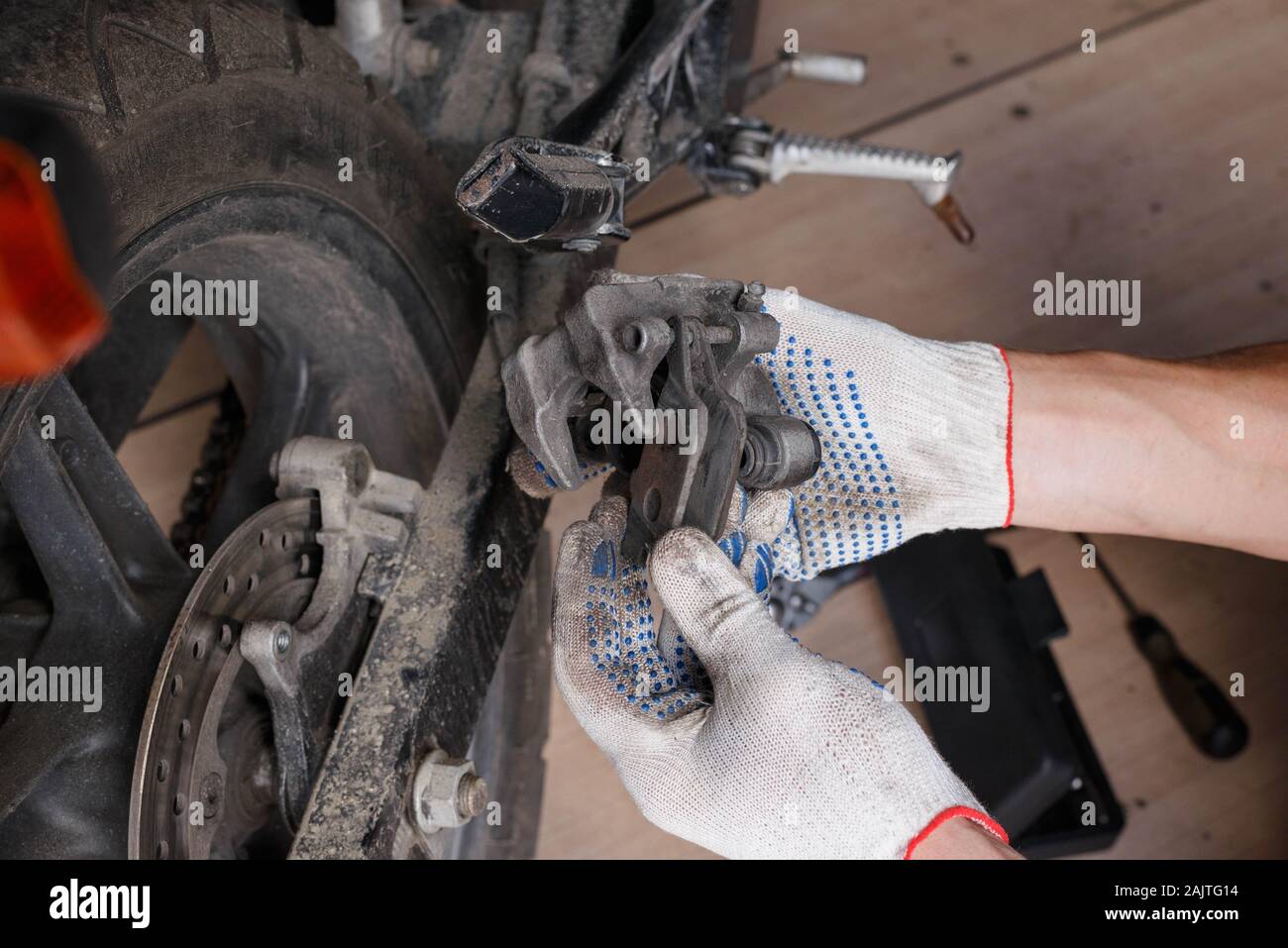 The process of replacing brake pads on a motorcycle. Maintenance