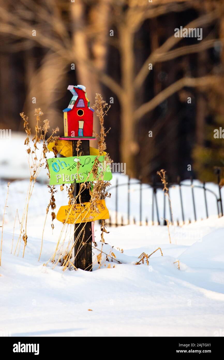 Colorful bird house and signs with snow on the ground in a Wisconsin winter Stock Photo