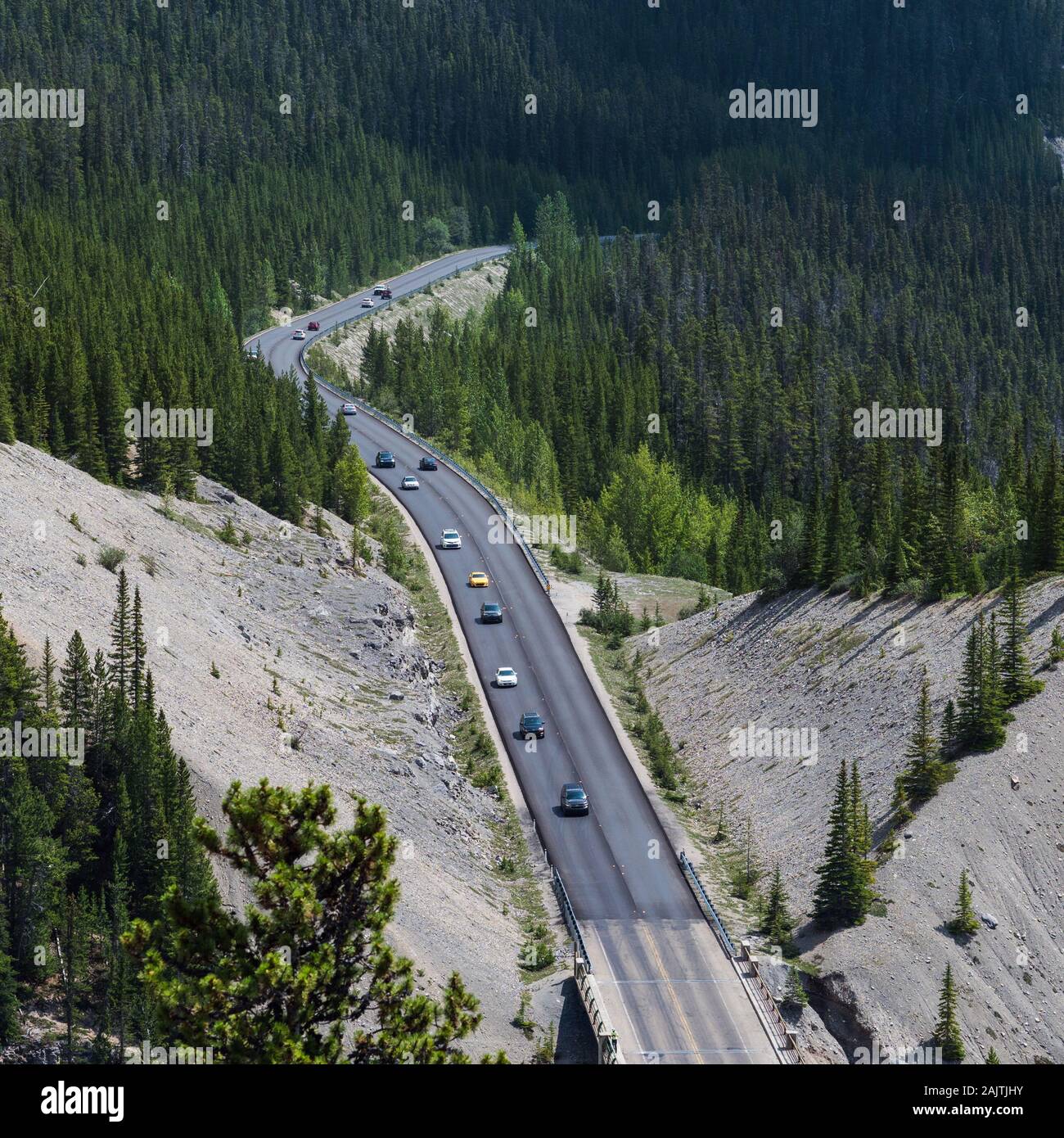 Vehicles driving down the iconic Icefields Parkway route between Banff and Jasper National Parks in Alberta, Canada. Stock Photo