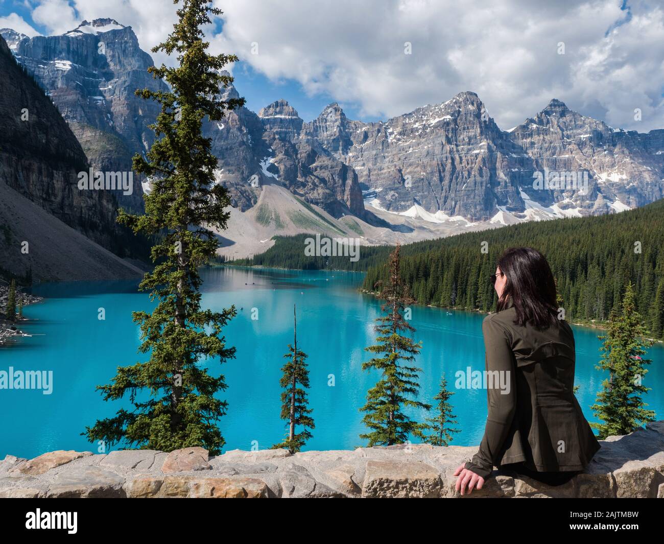 Female tourist looking at the view at Moraine Lake in Banff National Park, Canadian Rockies, Alberta, Canada. Stock Photo