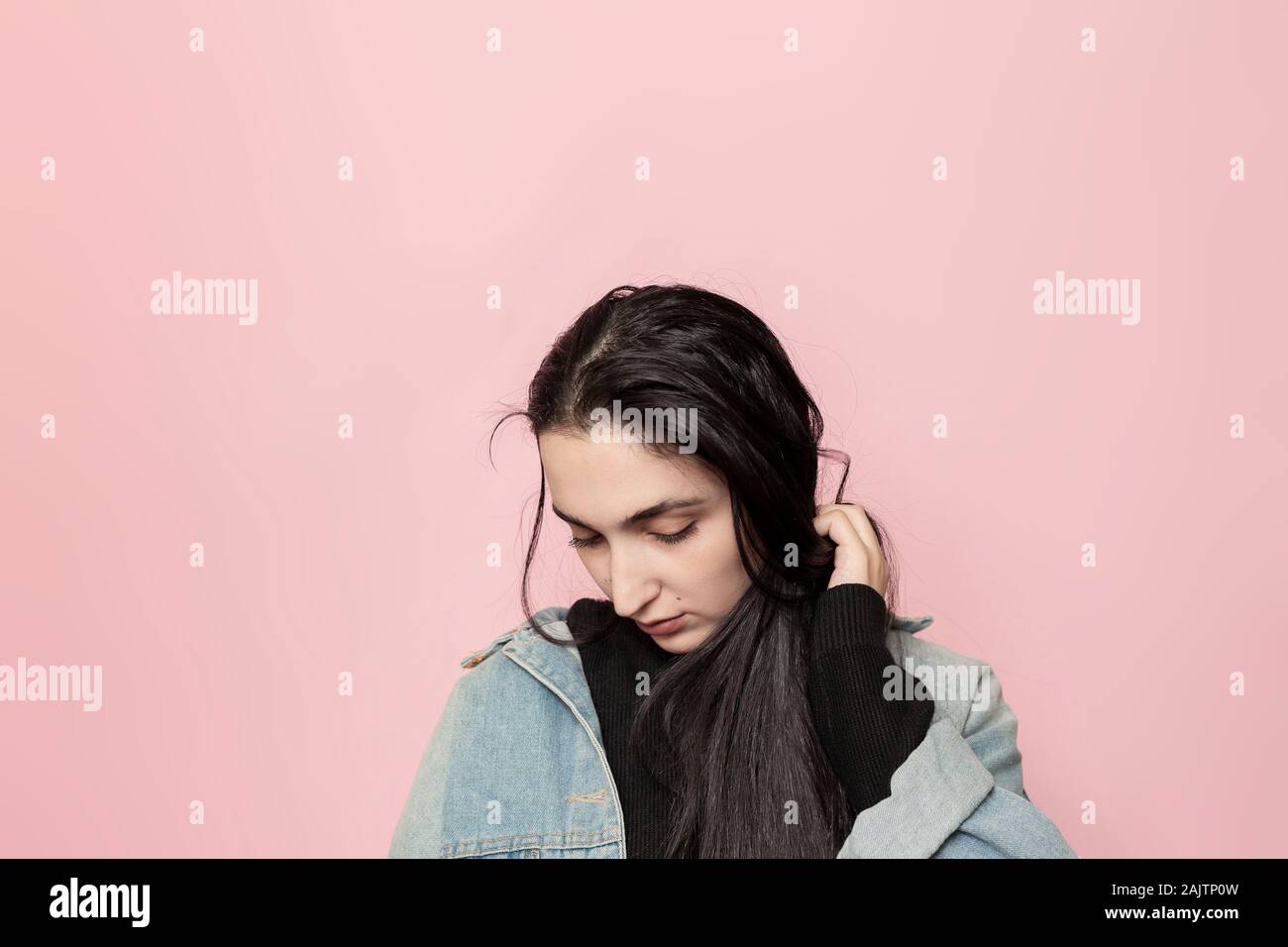 Portrait of happy middle-eastern female posing against a pink background. Studio portrait of a stylish young woman. Beauty, fashion, seasonal vogue Stock Photo
