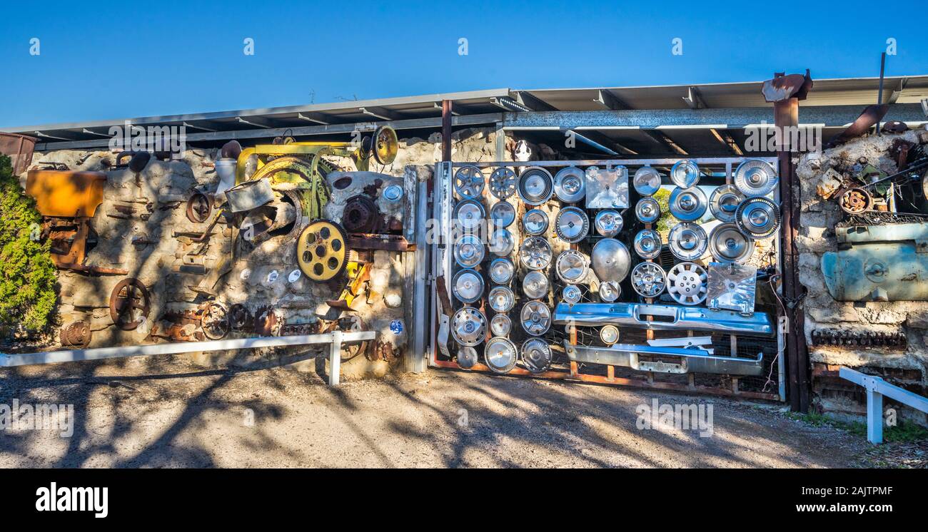 Arno's Wall in Winton, quirky outdoor installation studded with old lawnmower parts, boat propellers,  vintage typewriters, plaster figures, copper po Stock Photo