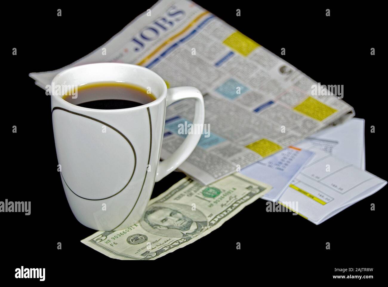 black coffee in mug with five dollar bill and help wanted ads in newspaper Stock Photo