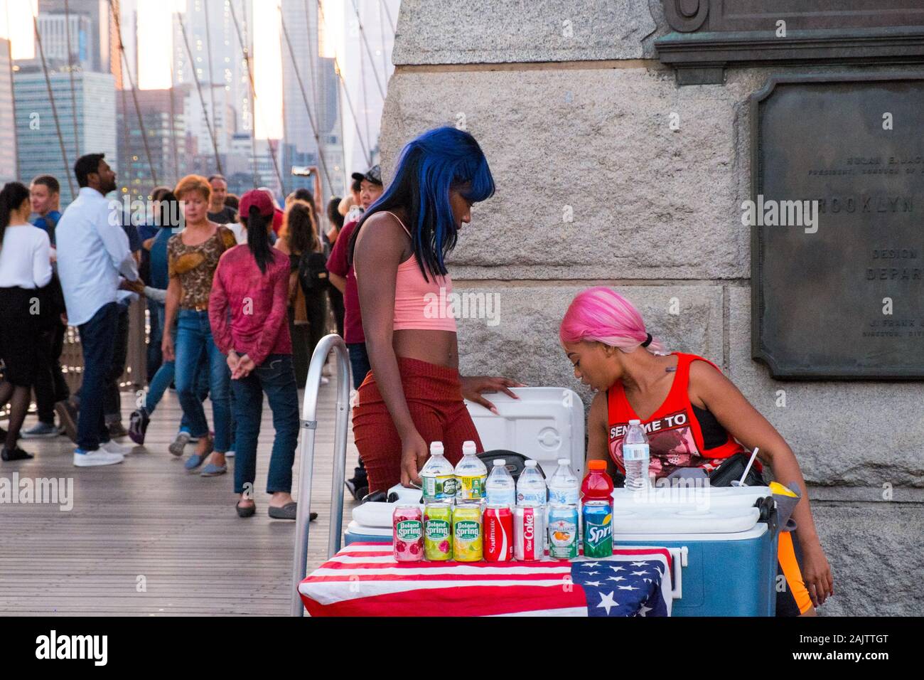Two women sell drinks at a soft drink stand on the Brooklyn Bridge, New York City, USA Stock Photo